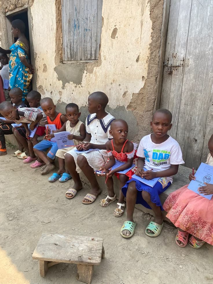 African children smiling and learning together in Uganda
