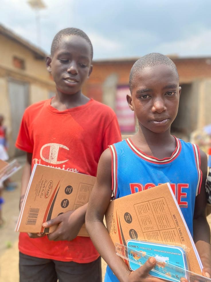 Children receiving school supplies and hygiene kits with dignity